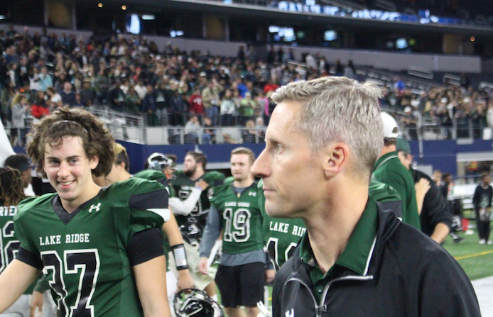Peyton Thor, far left, and Coach Kirk Thor, far right, walk off the field at AT&T Stadium in Arlington after a playoff victory against Longview. 
