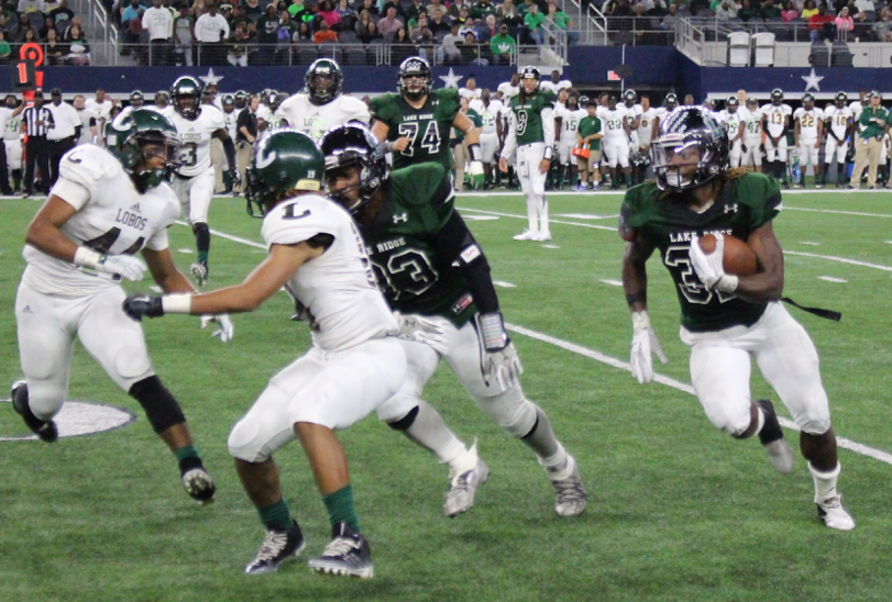 Lake Ridge running back Duke Carter carries the ball against Longview at A&T Stadium in D5A playoff action, Dec. 5, 2015.