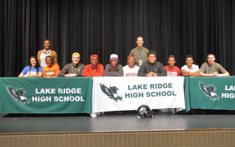 Athletes and coaches pose together during Signing Ceremony