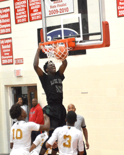 Langdon Williams (22) dunks the ball in the first round of the UIL State Playoffs against Dallas South Oak Cliff.