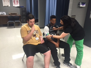 Seniors Zach Bell and Jevon Martin getting checked by the LR Nurse for Senioritis