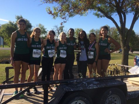 Girls varsity team standing with there runner up trophy