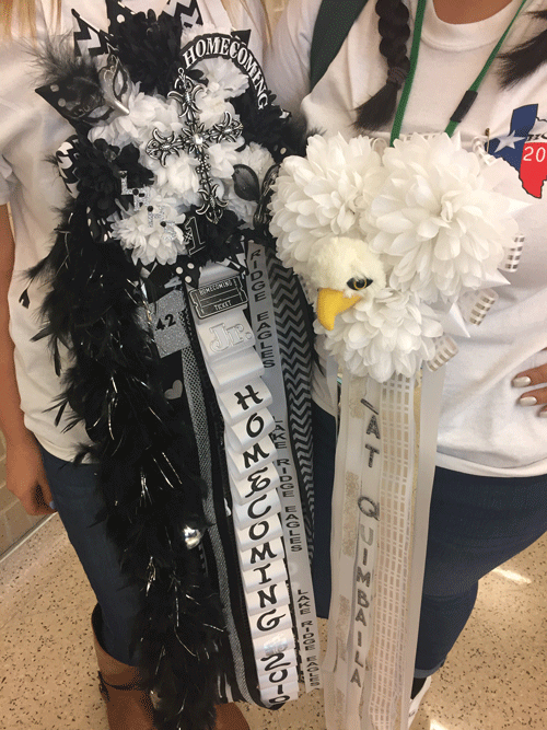 Students show off their mums before Homecoming.