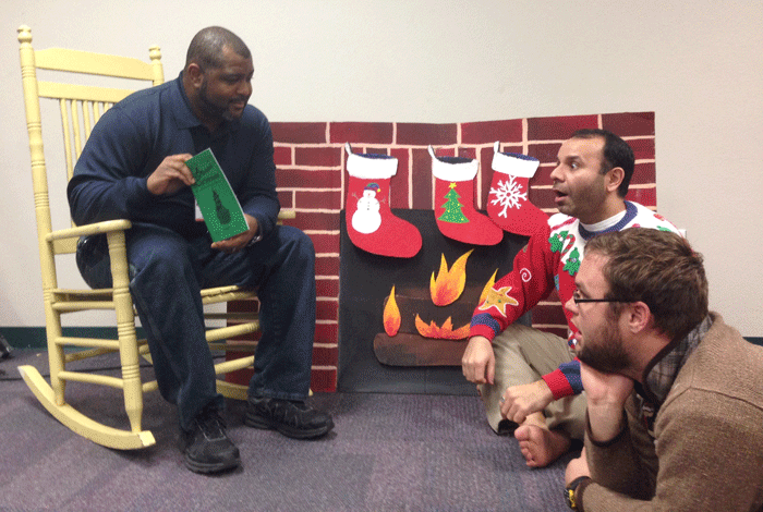 Coach Barnes reads a Christmas story to Marsh and Sohel.