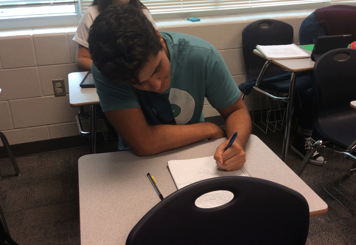 Ben Manoli taking notes in class