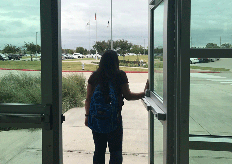 Tracy Nguyen walking out the front doors of Lake Ridge.