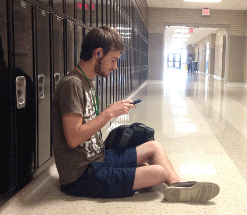Alex Ruthford listening to music in the hallway