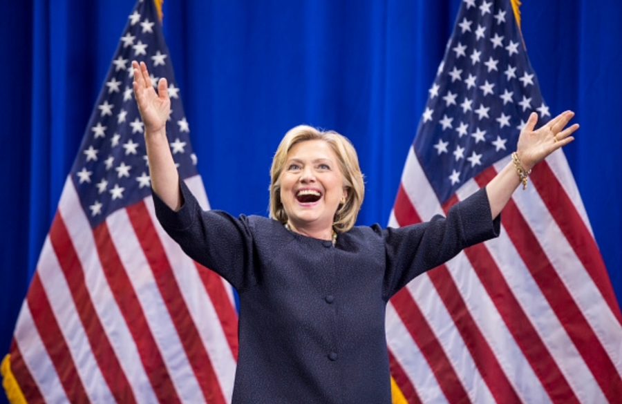 Presidential candidate, Hillary Clinton, raises her arms during the New Hampshire Democratic Party Convention.