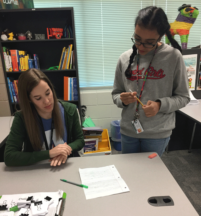 Mrs. Mohler helps a student with her Spanish work.