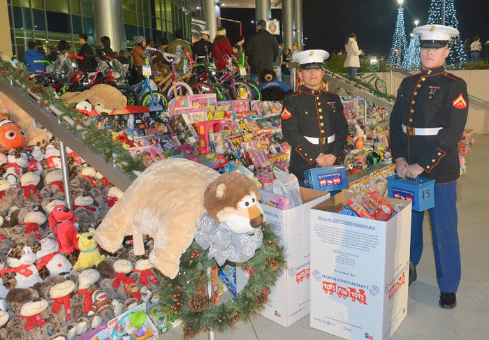 Marines accept toys during the annual MISD Toys for Tots drive.