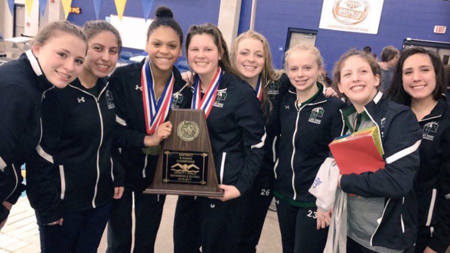 The Girls Swim Team with their trophy.
