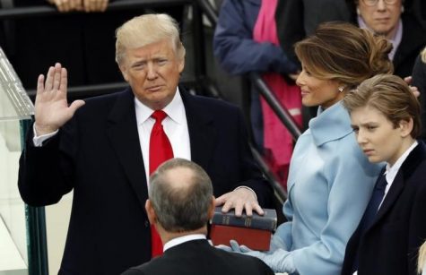 US President Donald Trump takes the oath of office with his wife Melania and son Barron at his side, during his inauguration at the U.S. Capitol in Washington, U.S., January 20, 2017. REUTERS/Kevin Lamarque