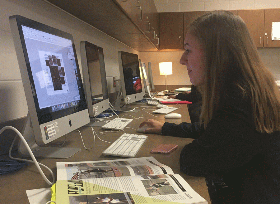 Emma Wolfe works on her spread at the yearbook work night.