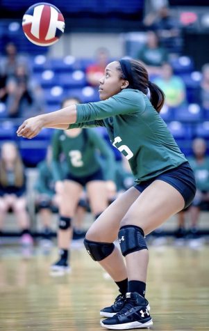 Freshman Trinity Bryant digs the ball