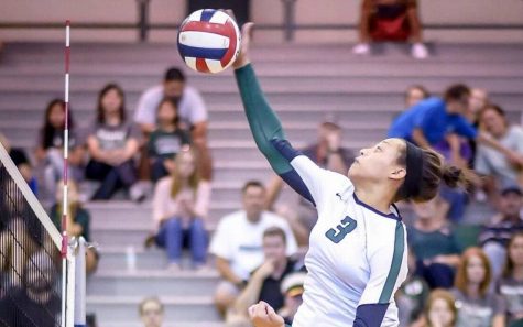 Capri Davis spiking the ball.