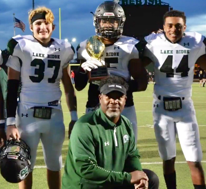 Coach Smith poses with a few of his players after a playoff victory.