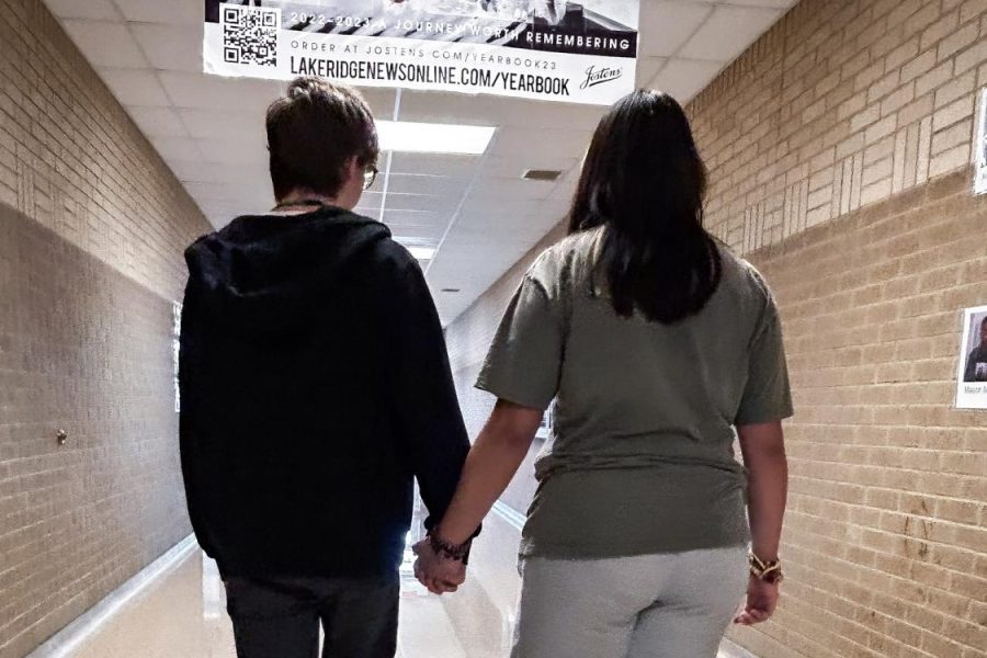 Couple at Lake Ridge High School walking the halls and holding each others hands. Photo courtesy of Tyler Quisenberry (ENN Staff)